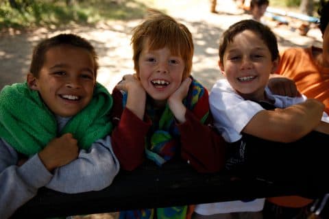 Three young boys enjoying camp activities